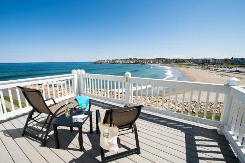 two chairs and a table on a balcony overlooking the beach at Union Bluff Hotel in York Beach