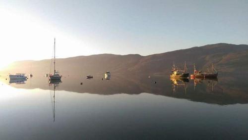 un groupe de bateaux assis sur une masse d'eau dans l'établissement Number 27, à Ullapool