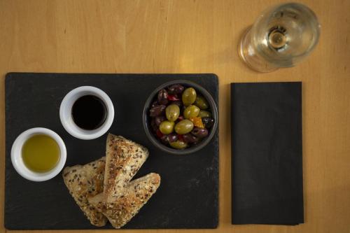 a plate of bread and a bowl of grapes and a cup of coffee at Holiday Inn Express Southampton - M27, J7 by IHG in Southampton