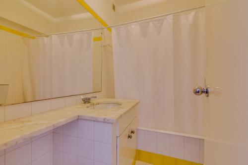 uma casa de banho com um lavatório e um chuveiro em Village Atlântico Apartment em Vilamoura