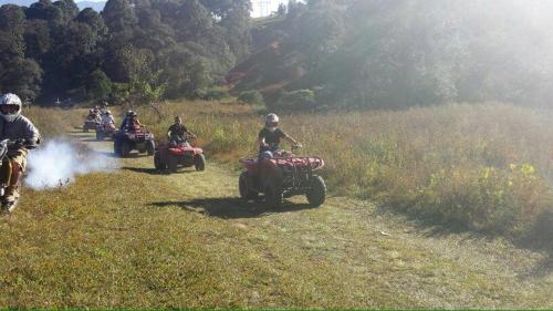 a group of people riding on atvs on a field at Hotel Rancho el Paraíso in Valle de Bravo