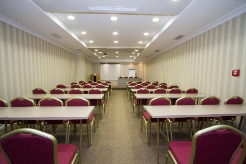 a room with rows of tables and chairs at Hotel Talija in Banja Luka
