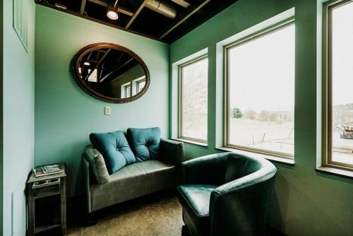a living room with a couch and a mirror at Hocking Hills Inn in Logan