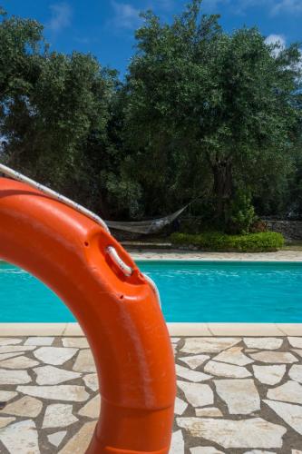 an orange slide in front of a swimming pool at Villa Elaia Suites & Apartments No.4 in Gaios