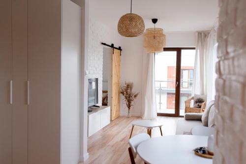 a living room with a couch and a table at Eco apartament Nałęczów in Nałęczów