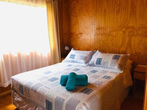a bed with a blue towel on top of it at Rangi Moana in Hanga Roa