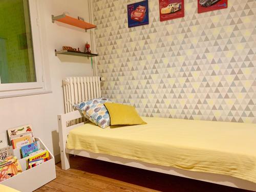 a bedroom with a bed and a wall at Maison de campagne Chez Trabou et Loulou 20 min de La Rochelle in Aigrefeuille-dʼAunis