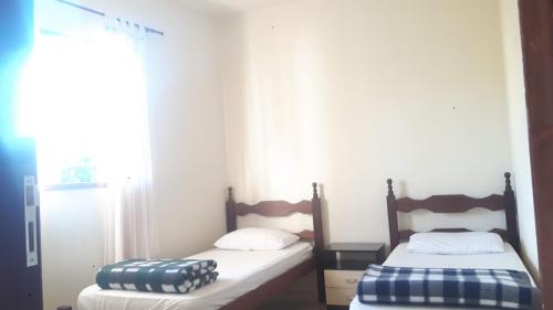 מיטה או מיטות בחדר ב-Casa do Nelson