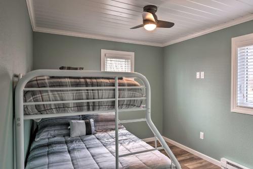 a bedroom with a bunk bed with a ceiling fan at The Lakefront Home - 5 Minutes From Detroit Lakes! in Detroit Lakes