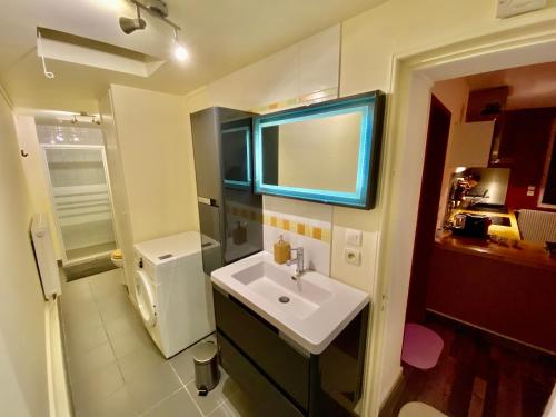a small bathroom with a sink and a toilet at Suite avec Jacuzzi et Sauna Privée in Évreux