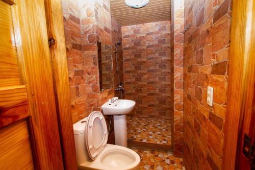 a small bathroom with a toilet and a sink at Sagada Lodging Home in Sagada