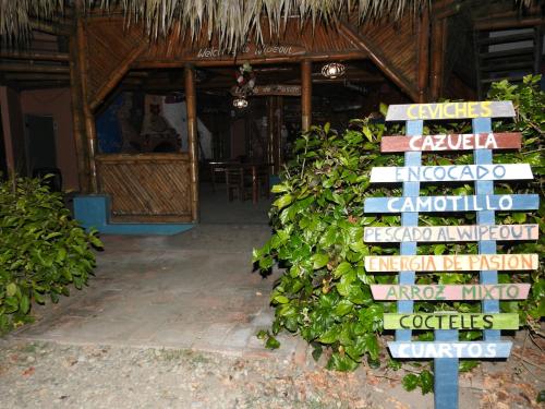 a sign in front of a house with a bunch of signs at Wipeout Cabaña Restaurant in Las Tunas