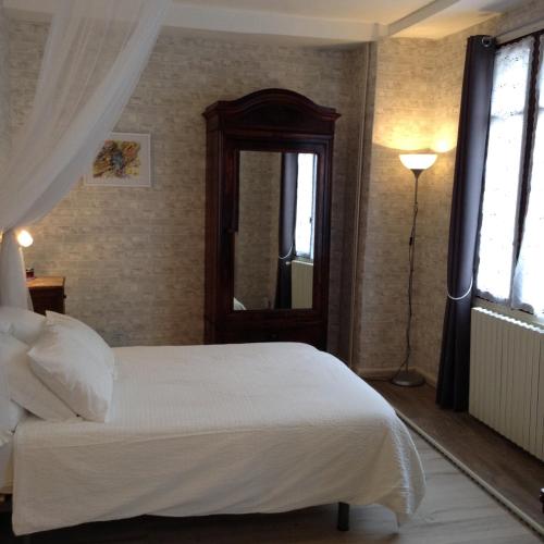 une chambre avec un lit blanc et une fenêtre dans l'établissement French Holiday Accommodation, à Bort-les-Orgues