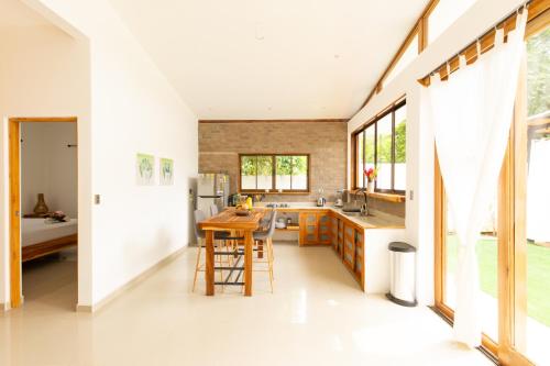a kitchen with a counter and a table and some windows at Villa Akari - Brand new 2bedrooms Villa with Pool in Carmen