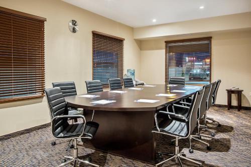 a conference room with a large table and chairs at Ramada by Wyndham Prince Albert in Prince Albert