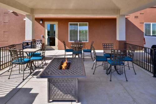 a patio with tables and chairs and a fire pit at Candlewood Suites - Lodi by IHG in Lodi