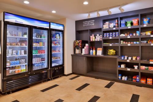 a store with a large refrigerator and shelves of food at Candlewood Suites - Lodi by IHG in Lodi