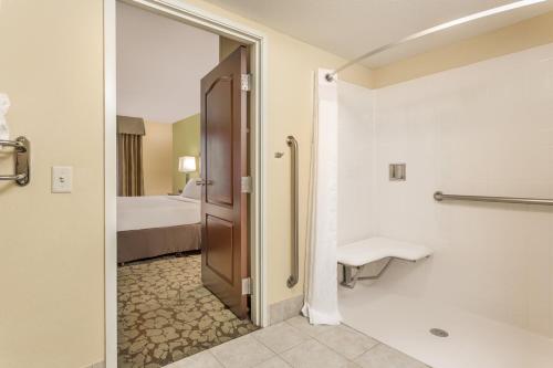 a bathroom with a shower and a toilet and a sink at Holiday Inn Chicago North - Gurnee, an IHG Hotel in Gurnee