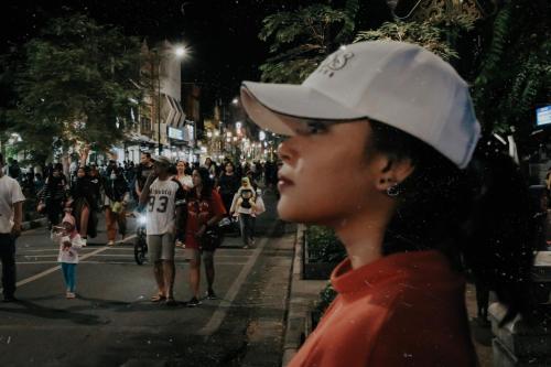 a woman in a white hat and a crowd of people at Griya Suryo Wijilan in Yogyakarta