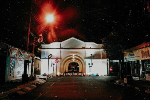 a white building with a street light in front of it at Griya Suryo Wijilan in Yogyakarta