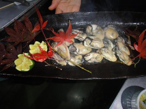 a plate of oysters and vegetables on a table at Oimatsuen in Saku