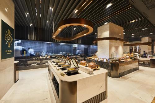 a large kitchen with a buffet in a restaurant at Lavalse Hotel in Busan