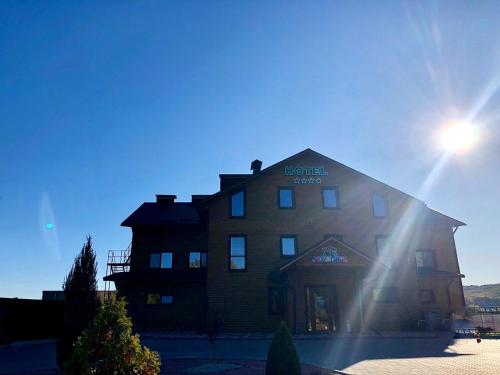 a large building with the sun shining on it at Глухомань Аквапарк in Poltava