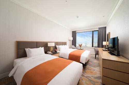 TV a/nebo společenská místnost v ubytování Jeju Sun Hotel & Casino