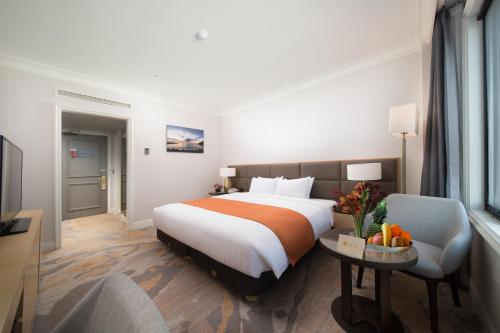 Postel nebo postele na pokoji v ubytování Jeju Sun Hotel & Casino