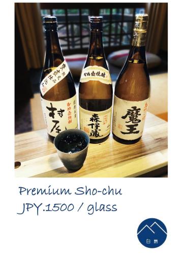 three bottles of wine sitting on top of a table at The Guest House Japan Hakuba in Hakuba