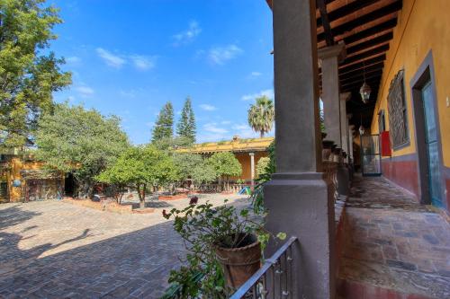 a porch of a building with a playground in the background at Hotel Sautto in San Miguel de Allende
