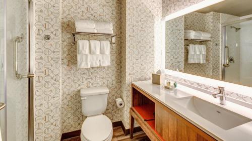 a bathroom with a toilet and a sink at Holiday Inn & Suites Bellingham by IHG in Bellingham