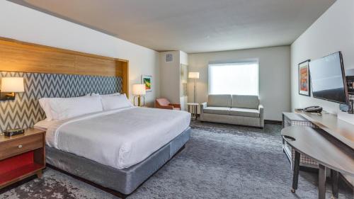 a hotel room with a large bed and a desk at Holiday Inn & Suites Bellingham by IHG in Bellingham