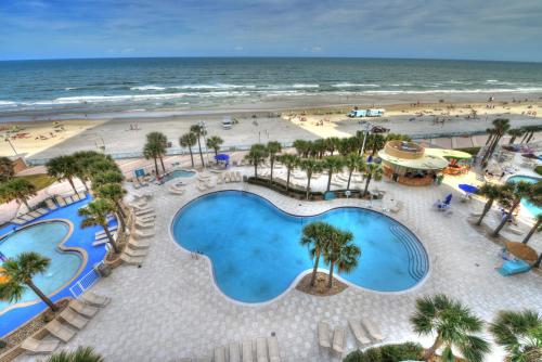 an aerial view of the beach and swimming pools at a resort at Wyndhams Ocean Walk Resort in Daytona Beach