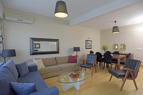 a living room with a couch and a table at Cheya Taksim Istanbul City Center Comfort Residence in Istanbul