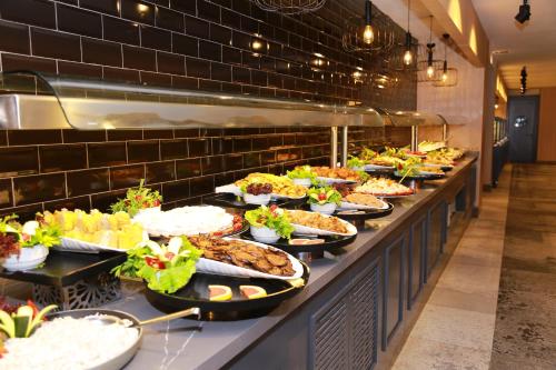a buffet line with many plates of food at Noxinn Deluxe Hotel - Ultra All Inclusive in Konaklı