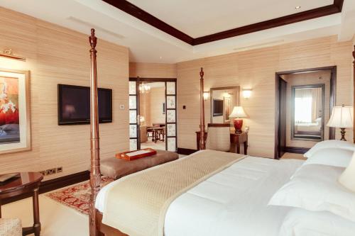 a bedroom with a bed and a flat screen tv at Lake Victoria Serena Golf Resort & Spa in Kigo