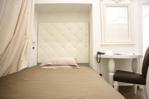 a bedroom with a bed and a sink and a window at Hotel Columbia Wellness & Spa in Montecatini Terme