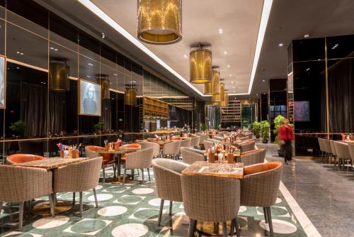 a restaurant with tables and chairs in a building at Hotel Indigo Shanghai Jing'An, an IHG Hotel in Shanghai