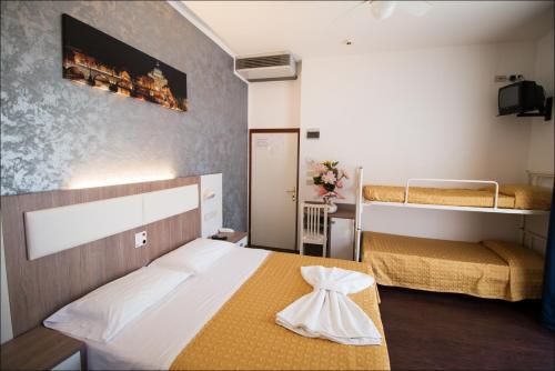a bedroom with two bunk beds and a bedvisor at Hotel Belfiore in Misano Adriatico