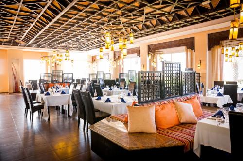 a dining room with tables and chairs and tablesearcher at ROBINSON AGADIR - All Inclusive in Agadir