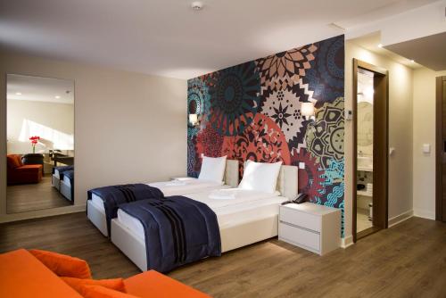 Giường trong phòng chung tại Zepter Hotel Drina Bajina Basta, member of Zepter Hotels