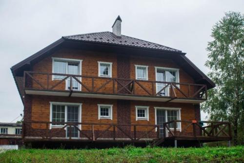 a large house with a balcony on top of it at Садиба Вікторія in Morshin