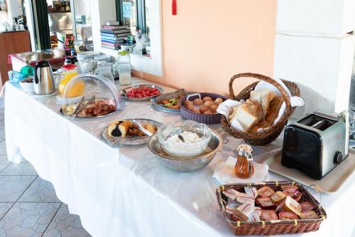 a buffet with bread and other foods on a table at Niforos Panorama in Vovikes