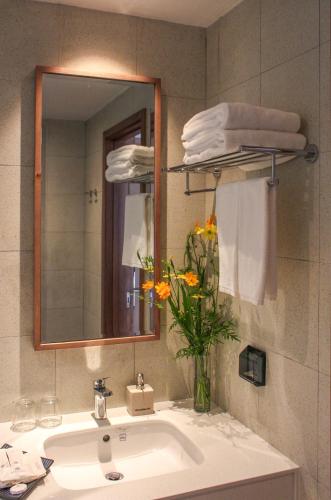 a bathroom with a sink and a mirror and towels at Minera Hot Springs Binh Chau in Binh Chau