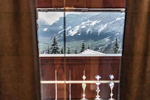 a window with a view of a snow covered mountain at Alpin View in Zellberg