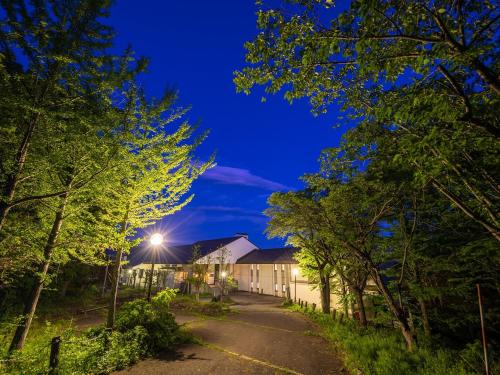 a house on a street at night with trees at Lake View Inawashiro in Inawashiro