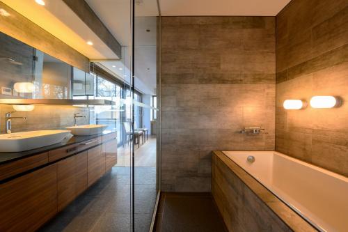 a bathroom with two sinks and a tub at Sekka Sekka in Niseko