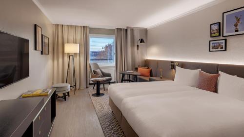a hotel room with a bed and a desk at Bilderberg Bellevue Hotel Dresden in Dresden