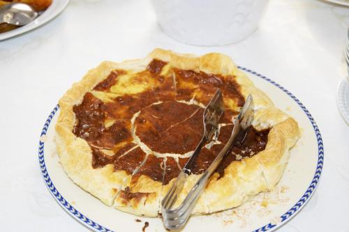 a pie on a plate with a fork on a table at Hotel Victoria in Torre Santa Sabina